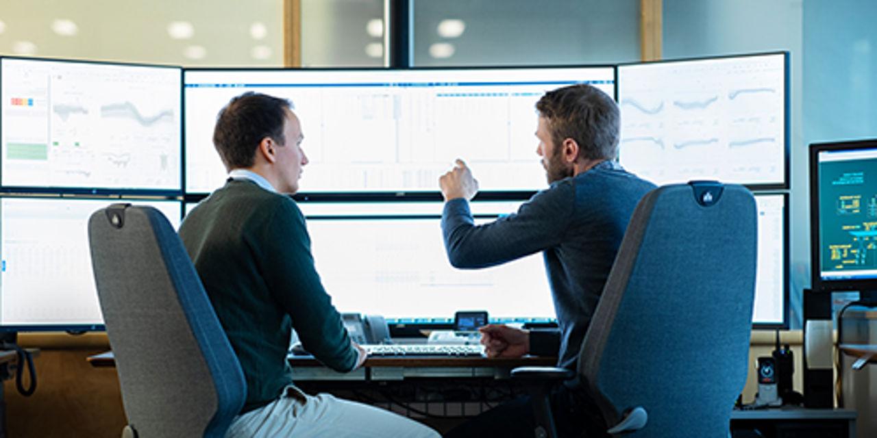 Men working on monitor